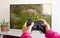 Girl playing video game, girl hands hold console gamepad against to television and playing console game at home. Gaming, weekend f
