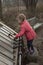 Girl playing a xylophone in a garden