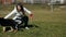 Girl plays ball with a German shepherd puppy on a green field. Pets.Slow motion