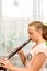 The girl plays the clarinet at the music school. Rehearsal before performing on stage