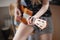 The girl plays the four-stringed guitar. Lesson playing ukulele. Love for music. Acoustic tool. Hands of a girl on the bar.