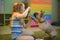 A girl plays with her pet, a French Bulldog dog. Child teaches the dog to give the paw