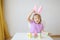 The girl plays with multi-colored eggs with rabbits of origami