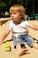 Girl plays sand on a beach