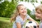 Girl plays soccer with brother