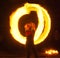 Girl with poi performs fire circle