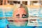 Girl in pool. head half in water