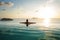 Girl in the pool at sunset with views of the mountains and the sea