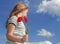 Girl with poppies over sky