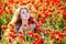 Girl on a poppy meadow