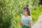 Girl poses with an air dandelion on the background of her face