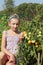 Girl poses in tomatoes garden