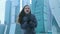 Girl posing against the backdrop of a skyscraper