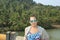 Girl posing on the brige near tropical forest