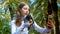 Girl posing in front of the Camera phone. Teenager in the park takes a Selfie with a dove.