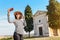 Girl posing in front of the old chapel in Tuscany