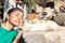 Girl posing next to a dozing cat, imitating his facial expression