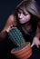 Girl posing in studio with cactus