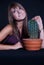 Girl posing in studio with cactus