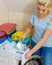 Girl pour washing powder into machine