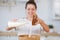 Girl pouring milk and pour flour into a wooden cup