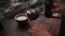 Girl pours cold brew coffee in a glass of ice in a cafe in the evening.