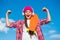 Girl power. Happy skater flex arms on blue sky. Little child with penny board outdoors. Power slide trick. Friction