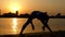 Girl Practice Yoga Pose Wide-Legged Forward Bend. the Action at Sunset on the