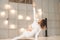 A girl practices yoga in a bright textured studio close-up. Meditation, woman, yoga, asanas, relaxation