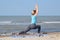 girl practices yoga by the sea. Exercise gymnastics in the fresh air by the sea