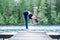 girl practicing yoga in the nature on the lake. Female happiness. Concept of healthy life and natural balance