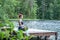 girl  practicing yoga in the nature on the lake. Female happiness. Landscape background