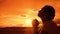 The girl prays. Girl folded her hands in prayer silhouette at sunset. slow lifestyle motion video. Girl folded her hands