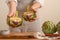 Girl prepares artichoke on a light background. Healthy eating concept. close-up