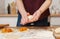 The girl prepares pies at home in the kitchen. Dough in hands close up