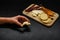 Girl prepares snacks top view. female hand takes bread with cheese from a common plate of snacks. sausage, camembert, suluguni on