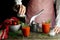 The girl prepares tomato juice with salt