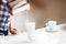 The girl is preparing morning coffee. the girl pours milk in a latte