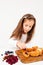 Girl preparing sweet cakes with berries