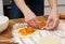 Girl preparing vegetarian pies with filling at home in the kitchen close-up