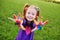 Girl preschooler shows palms stained with multicolored finger paints