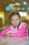 Girl-preschooler sitting at table