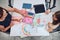 Girl presenting her artwork teacher. Woman assisting schoolgirl during classes at primary school. Child drawing picture sitting at