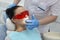 Girl on preventive reception at dentist. doctor smears lips to patient
