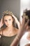 Girl princess and reflection in mirror. Woman wear jewelry crown at mirror. Beauty queen with glamour look in dressing