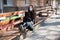 Girl in a protective mask on her face sits on benches in a public place