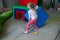 Girl with a psychologist plays in colored soft cubes. preschool education