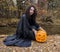 Girl with pumpkin by the river