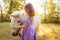 Girl in purple dress hugging white unicorn horse. Dreams come true. Fairy tale