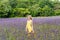 Girl in purple flowers outdoors in summer